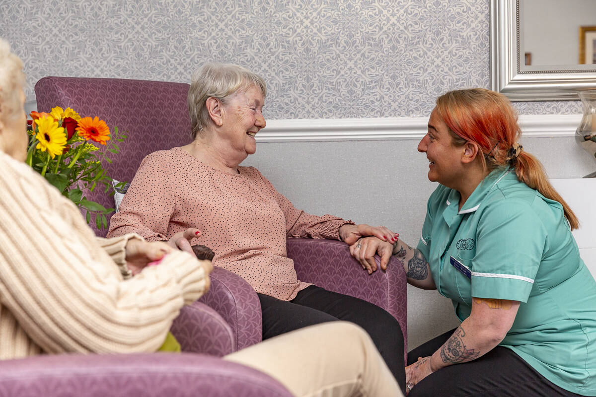 nurse and resident in the lounge area