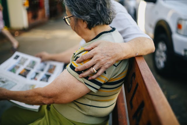 couple with arm round each other on a bench